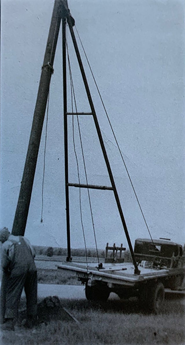 Setting electric poles in the late 1930s.