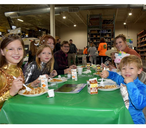 Family eating at Member Appreciation Breakfast.