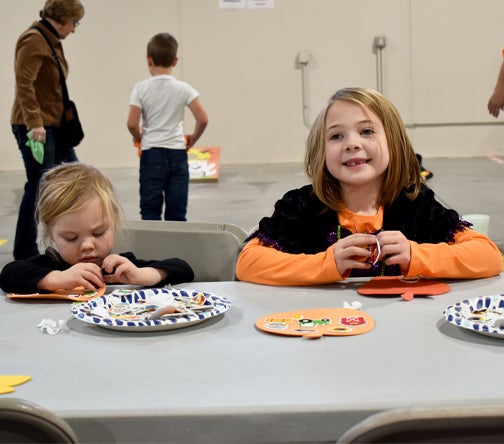 Two children making crafts. 