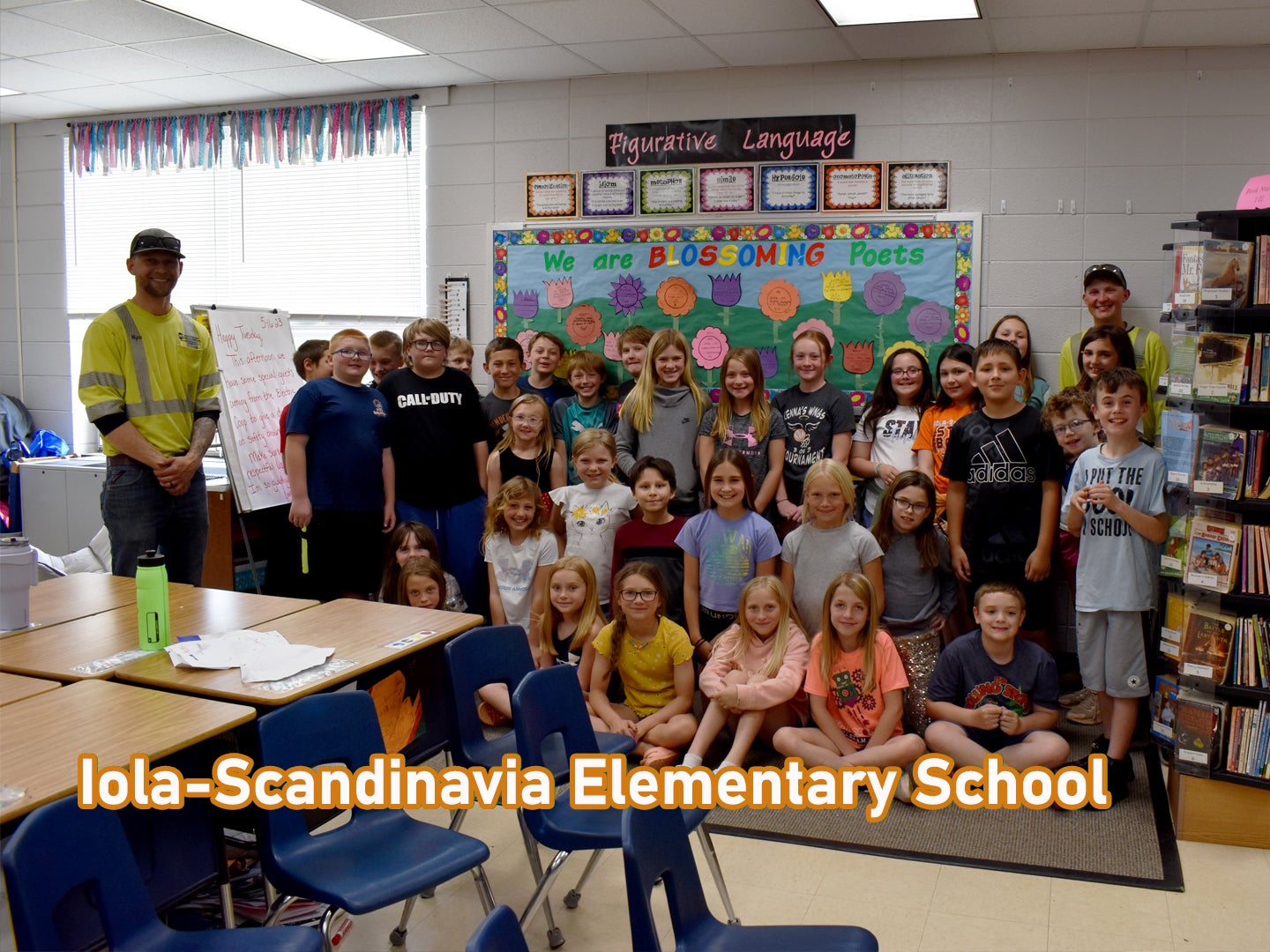 CWEC linemen Wyatt Phillips & Alex Lutz with the Iola-Scandinavia Elementary School 4th grade class